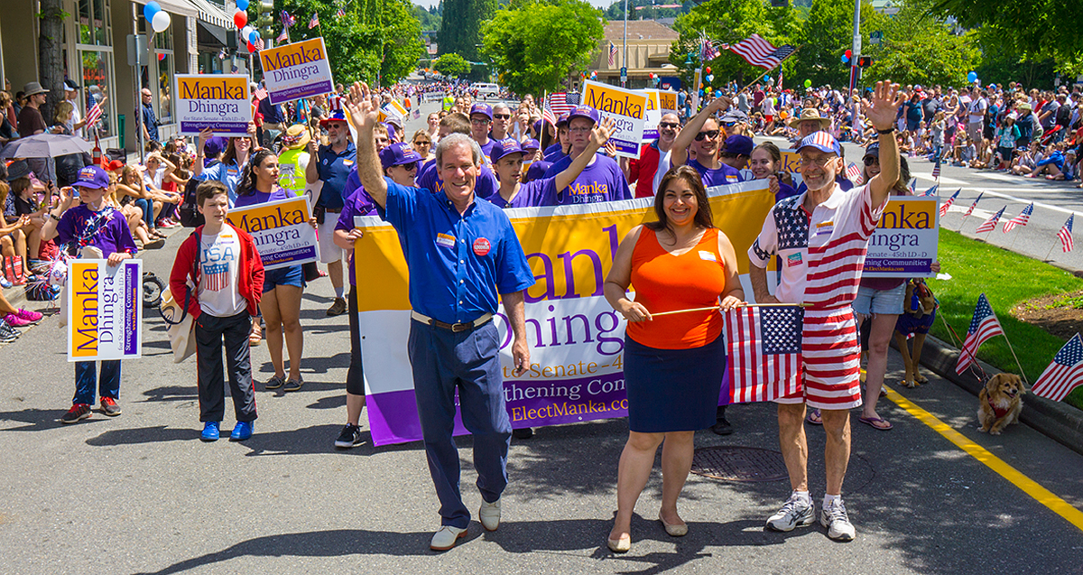 Manka Dhingra marches with Roger Goodman, Larry Springer, and a crowd of supporters in Kirkland.