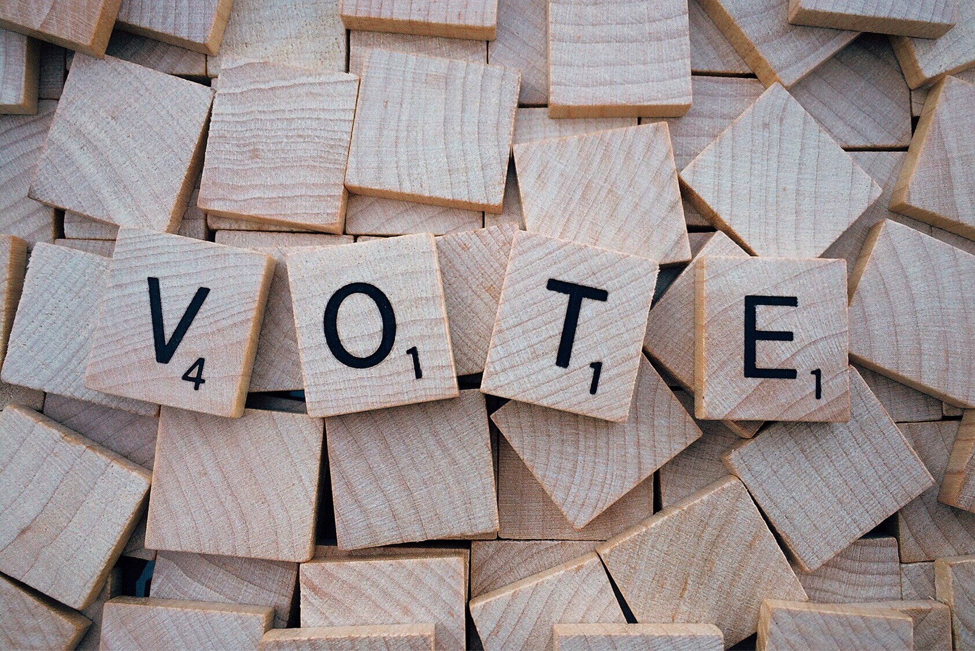 "VOTE" spelled in Scrabble tiles